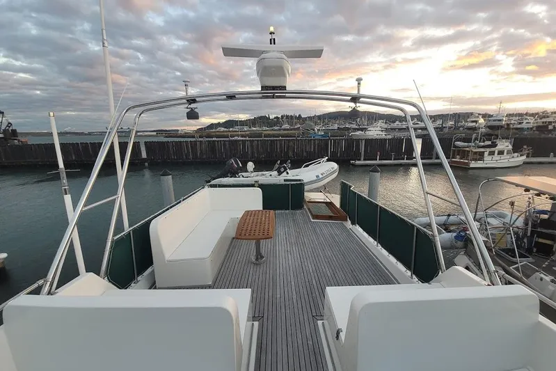 Goodlife Yacht Photos Pics 1998 Grand Banks 46 Europa yacht deck at sunset, docked in a marina.