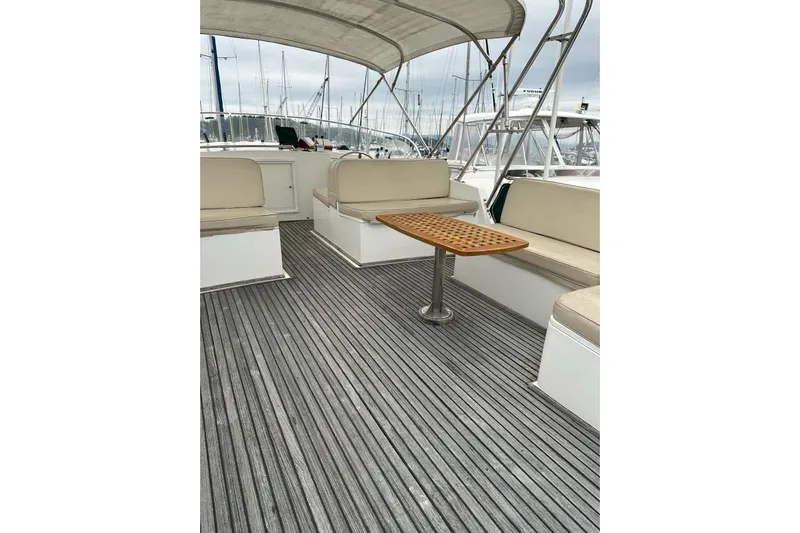 Goodlife Yacht Photos Pics 1998 Grand Banks 46 Europa yacht deck with seating and wooden table.