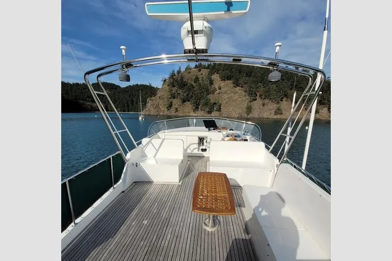 Goodlife Yacht Photos Pics 1998 Grand Banks 46 Europa yacht deck with scenic coastal backdrop.