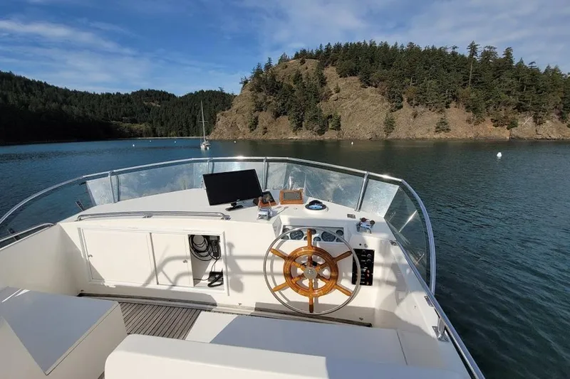 Goodlife Yacht Photos Pics 1998 Grand Banks 46 Europa yacht helm with scenic water and forested island view.