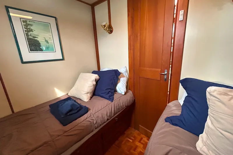 Goodlife Yacht Photos Pics Cozy cabin interior of 1998 Grand Banks 46 Europa with twin beds and wooden decor.