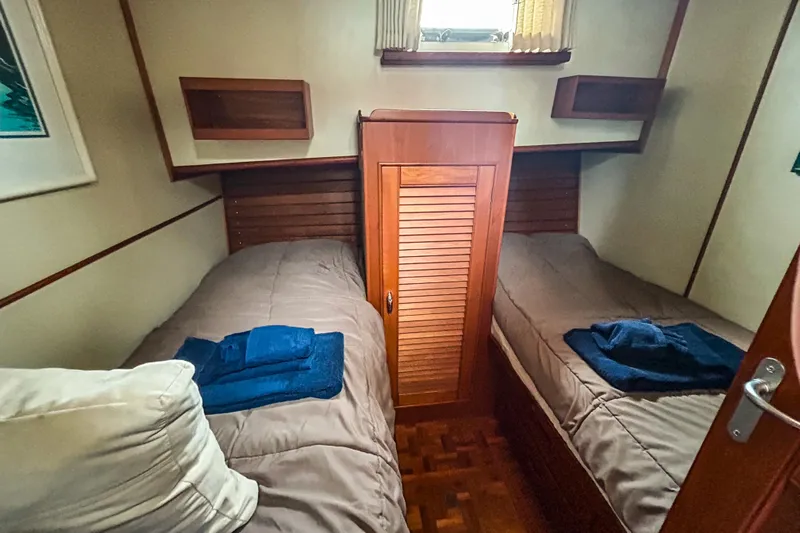 Goodlife Yacht Photos Pics Cabin interior of 1998 Grand Banks 46 Europa with twin beds and wooden accents.