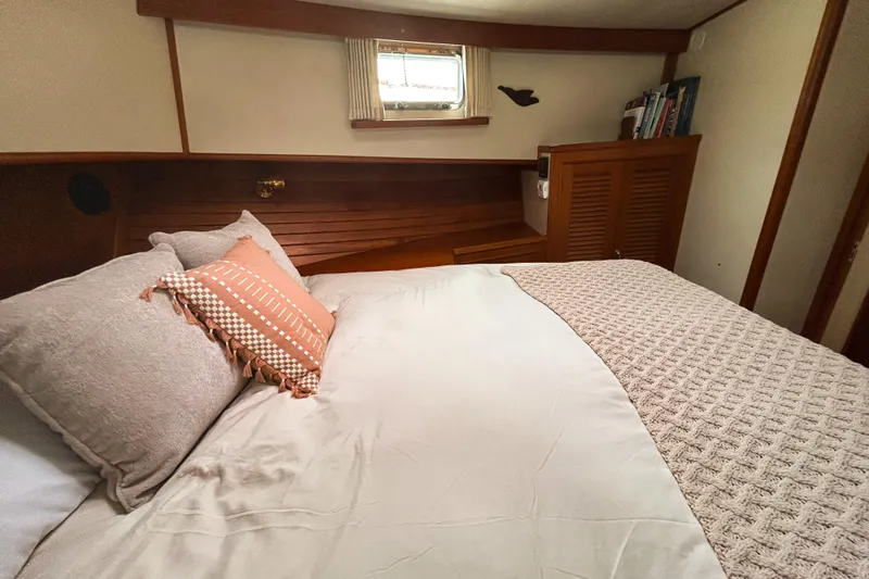 Goodlife Yacht Photos Pics Cozy bedroom interior of 1998 Grand Banks 46 Europa yacht with elegant bedding.