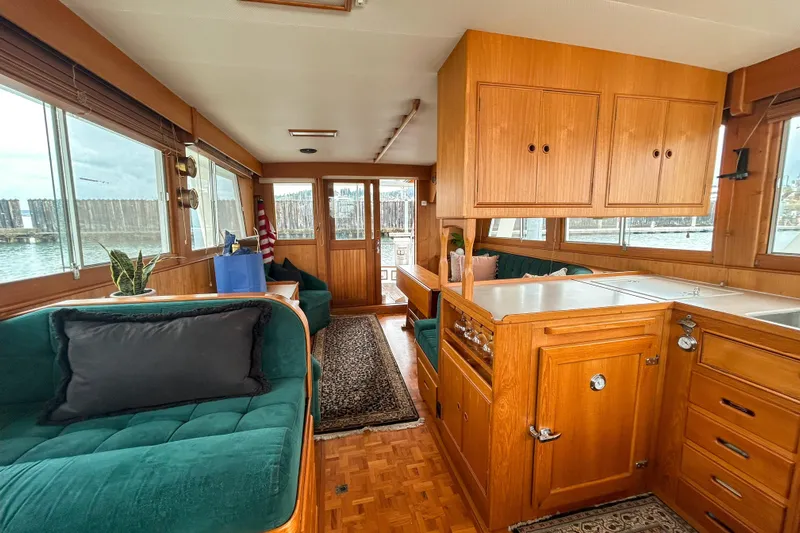 Goodlife Yacht Photos Pics Interior of 1998 Grand Banks 46 Europa yacht with wood cabinetry and green seating.