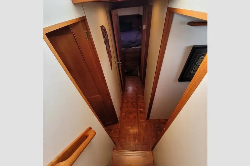 Goodlife Yacht Photos Pics Interior hallway of 1998 Grand Banks 46 Europa yacht with wooden flooring and doors.