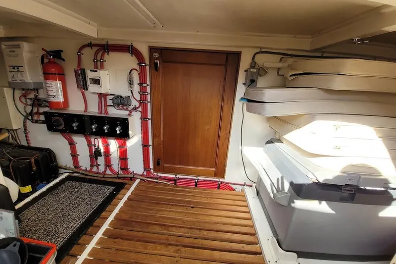 Goodlife Yacht Photos Pics Engine room of 1998 Grand Banks 46 Europa with fire extinguisher and electrical panel.