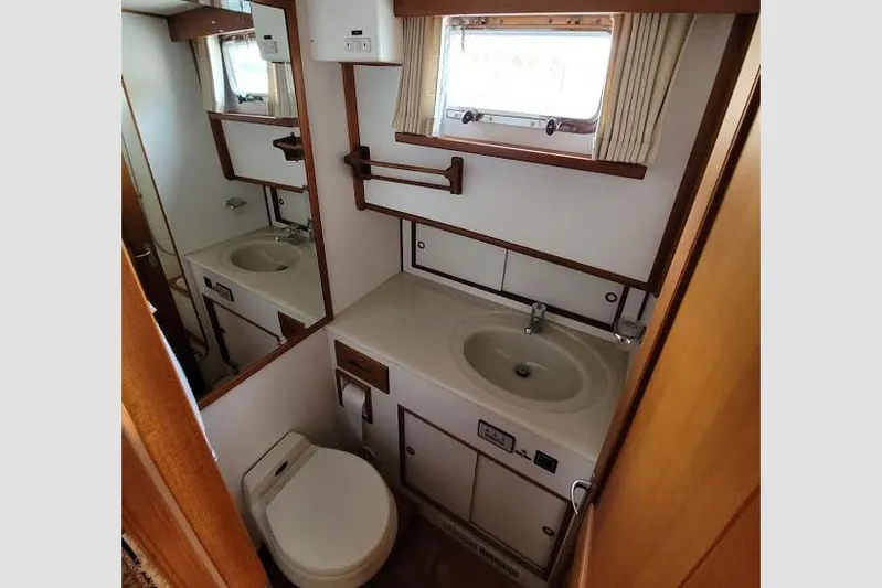 Goodlife Yacht Photos Pics Bathroom interior of 1998 Grand Banks 46 Europa yacht, featuring sink and toilet.