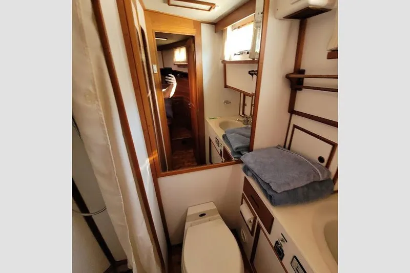 Goodlife Yacht Photos Pics Bathroom interior of 1998 Grand Banks 46 Europa yacht, featuring sink and toilet.