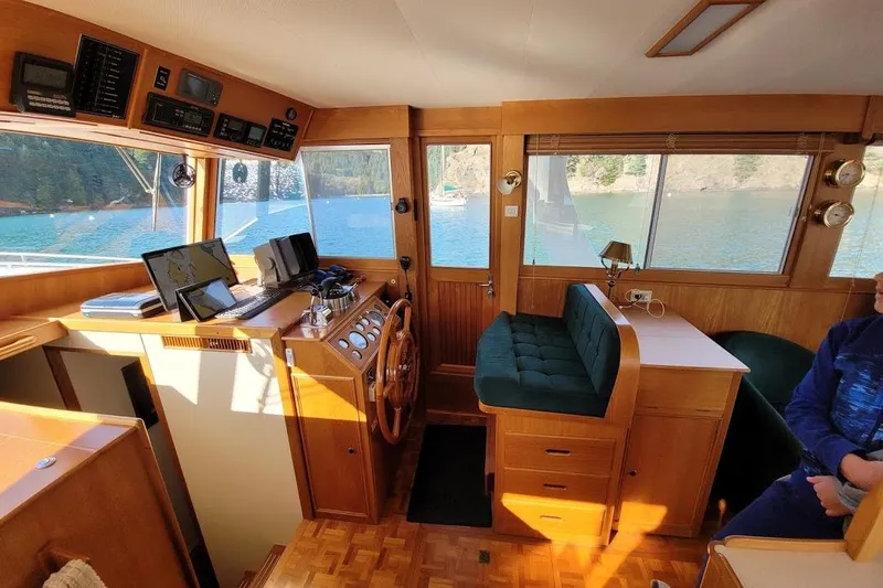 Goodlife Yacht Photos Pics Interior of 1998 Grand Banks 46 Europa yacht with helm, seating, and scenic water view.