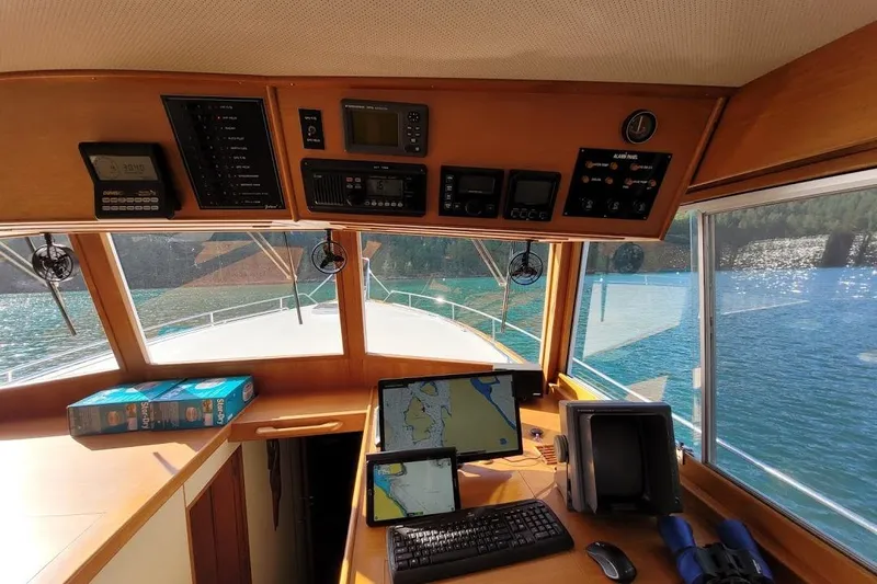 Goodlife Yacht Photos Pics 1998 Grand Banks 46 Europa helm with navigation equipment, overlooking serene waters.