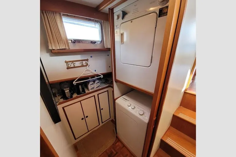 Goodlife Yacht Photos Pics Laundry area in 1998 Grand Banks 46 Europa yacht with washer, dryer, and storage cabinets.