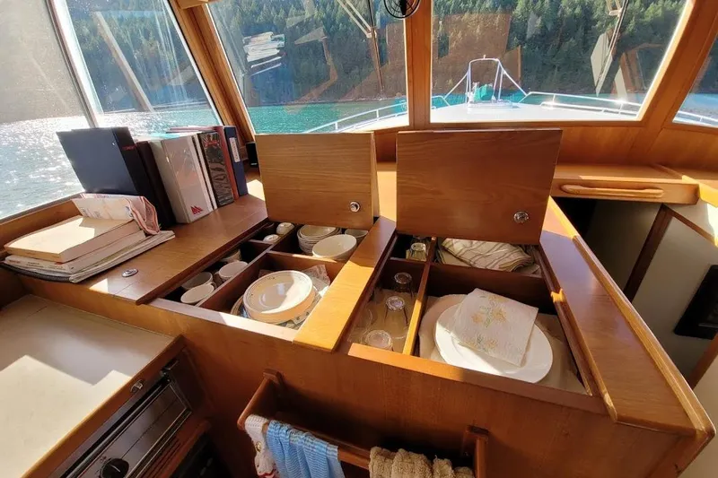 Goodlife Yacht Photos Pics Interior of 1998 Grand Banks 46 Europa yacht with organized kitchen storage and scenic window view.