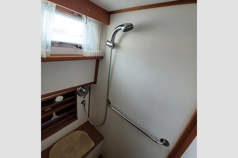 Goodlife Yacht Photos Pics Shower area in 1998 Grand Banks 46 Europa yacht with handheld showerhead and grab bar.