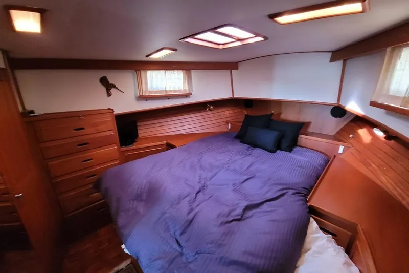 Goodlife Yacht Photos Pics Cozy bedroom in 1998 Grand Banks 46 Europa yacht with wood paneling and skylights.
