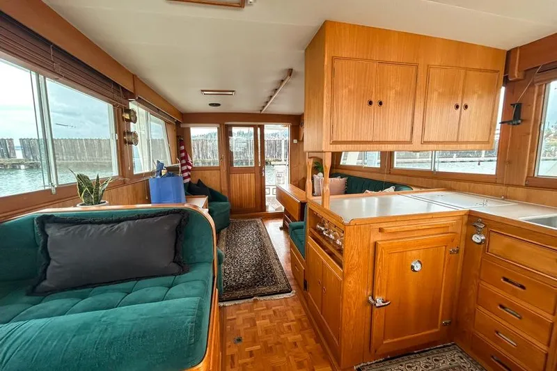 Goodlife Yacht Photos Pics Interior of 1998 Grand Banks 46 Europa yacht with wood cabinetry and green seating.