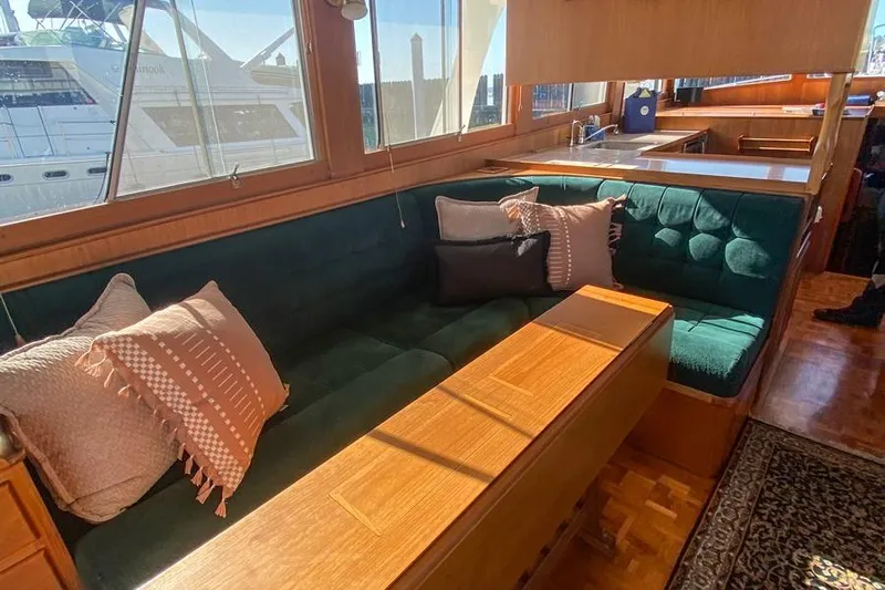 Goodlife Yacht Photos Pics Interior of 1998 Grand Banks 46 Europa yacht with cozy seating and wooden table.