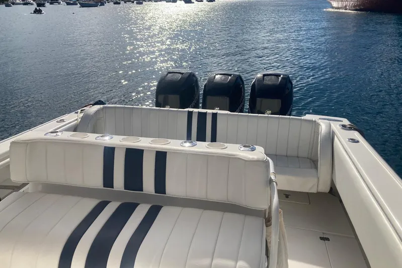 Runaway Bunny Yacht Photos Pics 2006 Intrepid 370 Cuddy boat with triple engines, white seating, and ocean view.