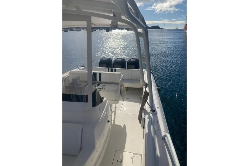 Runaway Bunny Yacht Photos Pics 2006 Intrepid 370 Cuddy boat on calm water, featuring a sleek deck and multiple engines.