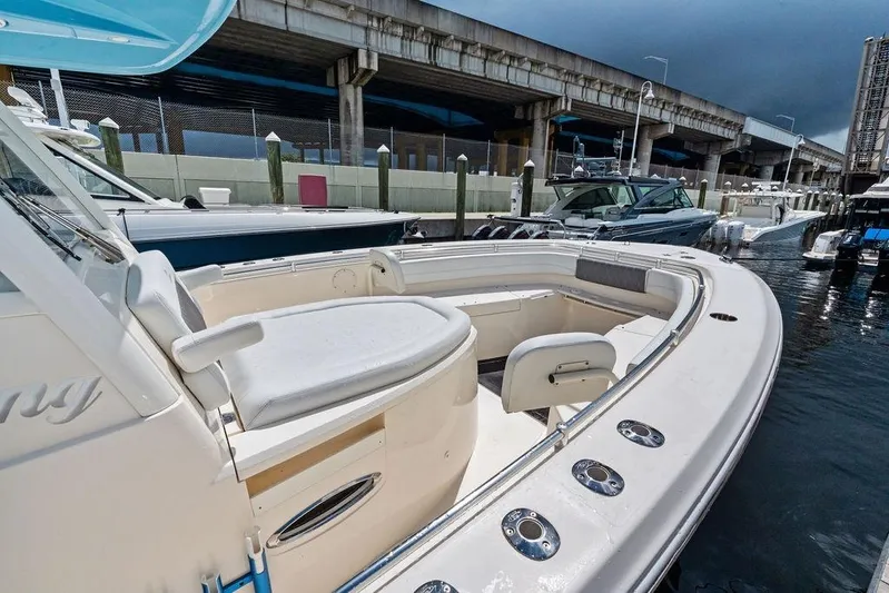  Yacht Photos Pics 2021 Cobia 350 Center Console boat docked near a bridge, showcasing spacious seating.