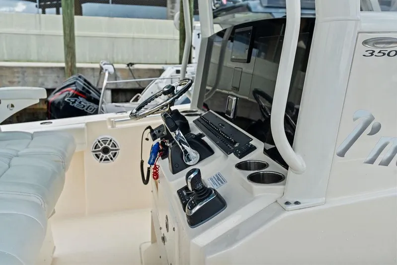  Yacht Photos Pics 2021 Cobia 350 Center Console boat interior with steering wheel and controls.