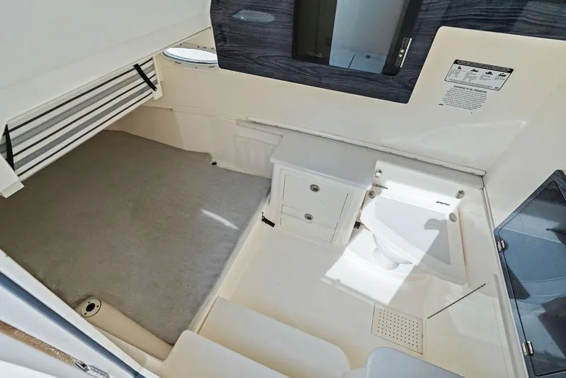  Yacht Photos Pics 2021 Cobia 350 Center Console cabin interior with bed and compact bathroom.