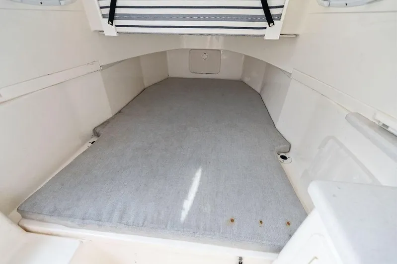  Yacht Photos Pics 2021 Cobia 350 Center Console cabin interior with cushioned flooring.