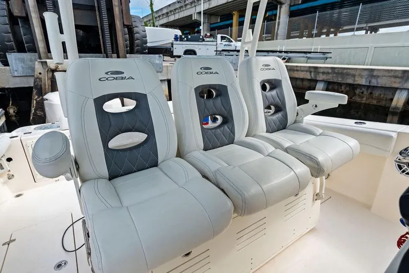  Yacht Photos Pics 2021 Cobia 350 Center Console boat with luxurious seating in a marina setting.