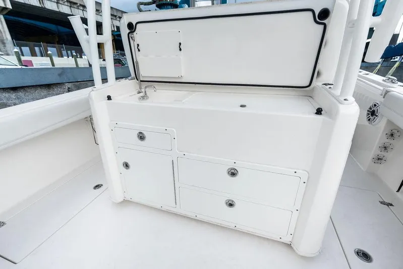  Yacht Photos Pics 2021 Cobia 350 Center Console boat interior with storage compartments and sink.