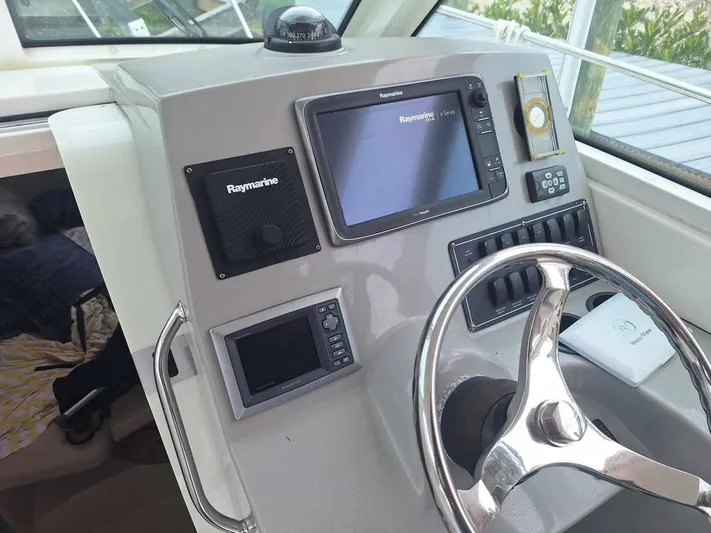  Yacht Photos Pics 2013 Boston Whaler 285 Conquest helm with Raymarine electronics and steering wheel.