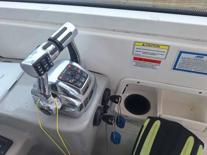  Yacht Photos Pics Control panel of a 2013 Boston Whaler 285 Conquest boat with throttle and warning labels.