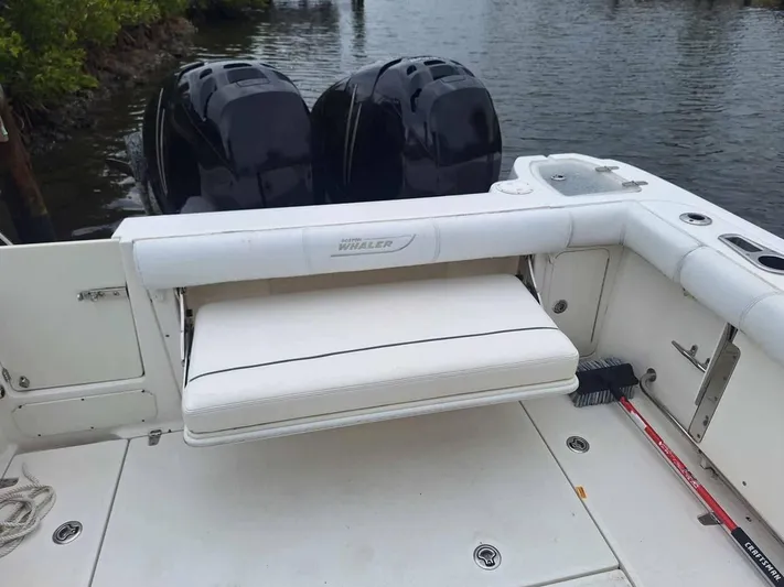  Yacht Photos Pics 2013 Boston Whaler 285 Conquest boat with dual engines and white seating.