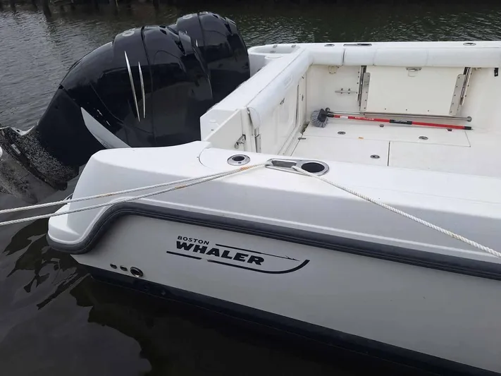 Yacht Photos Pics 2013 Boston Whaler 285 Conquest boat docked, featuring spacious deck and powerful engines.