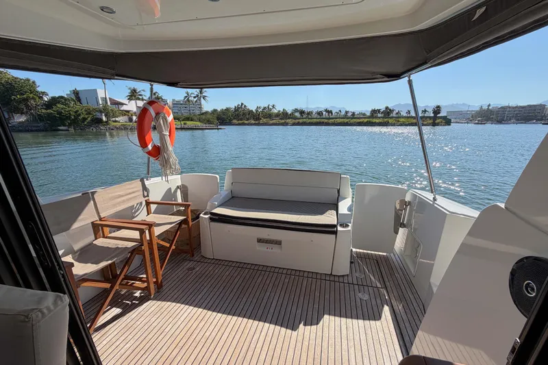 Requin Yacht Photos Pics 2019 Jeanneau NC 11 boat deck with seating, wooden flooring, and scenic waterfront view&nbsp;for sale in Mexico by Servicios Nauticos and Gaston Troche