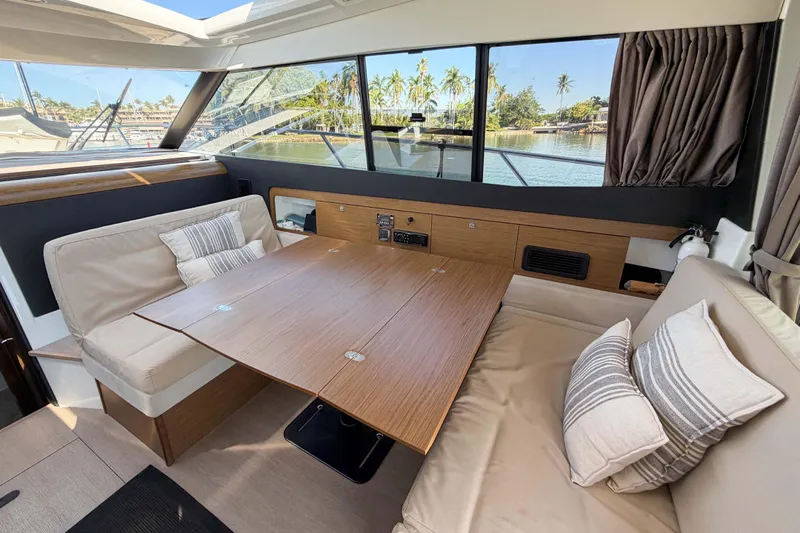 Requin Yacht Photos Pics Interior of 2019 Jeanneau NC 11 yacht with cozy seating and wooden table&nbsp;&nbsp;for sale in Mexico by Servicios Nauticos and Gaston Troche