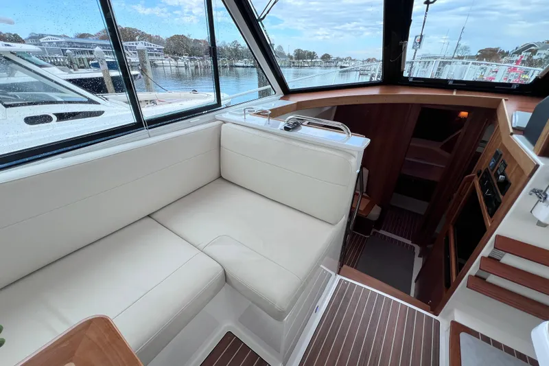 Wally World Yacht Photos Pics 2024 Back Cove 39O yacht interior with plush seating and scenic marina view.
