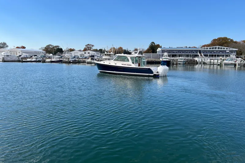 Wally World Yacht Photos Pics 2024 Back Cove 39O boat docked in a serene marina setting.