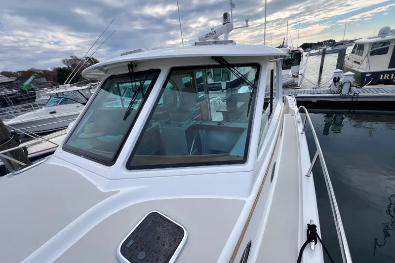 Wally World Yacht Photos Pics 2024 Back Cove 39O yacht docked at marina under cloudy sky.