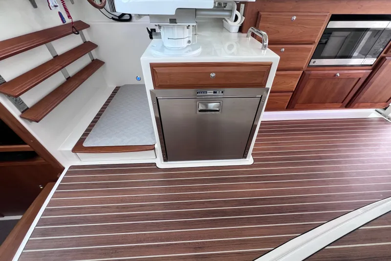 Wally World Yacht Photos Pics 2024 Back Cove 39O yacht interior with wood flooring and modern kitchen appliances.