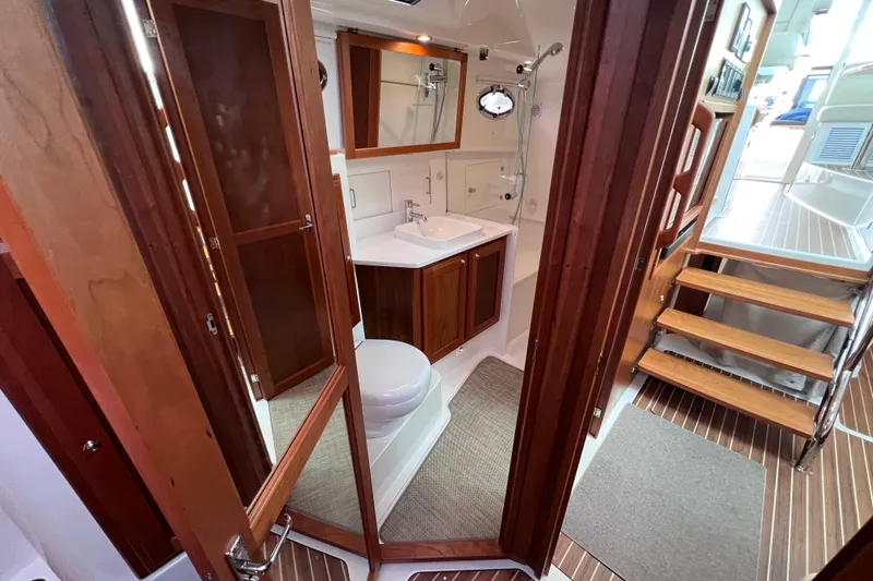 Wally World Yacht Photos Pics 2024 Back Cove 39O yacht interior with wooden cabinetry and modern bathroom.