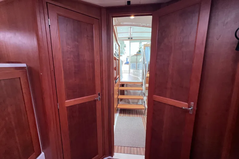 Wally World Yacht Photos Pics Interior view of 2024 Back Cove 39O yacht with wooden doors and staircase.