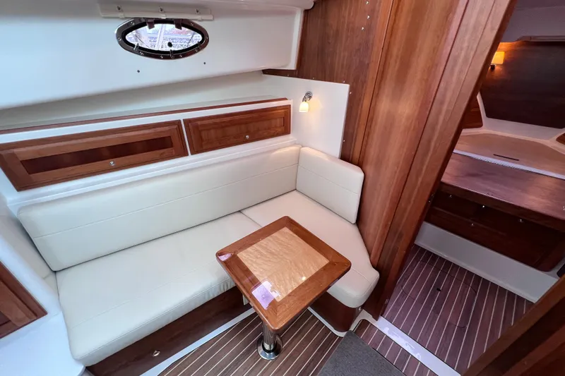Wally World Yacht Photos Pics Luxurious interior of 2024 Back Cove 39O yacht with elegant wood and leather seating.