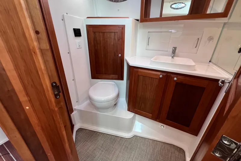 Wally World Yacht Photos Pics 2024 Back Cove 39O yacht bathroom with wooden cabinetry and modern fixtures.