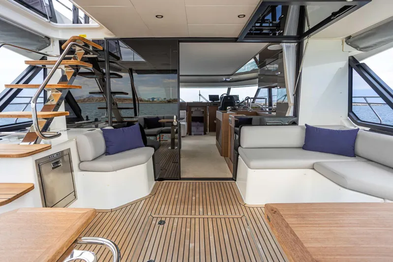  Yacht Photos Pics Luxurious 2024 Prestige M48 yacht interior with modern seating and elegant wooden flooring.