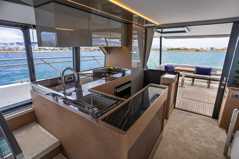  Yacht Photos Pics Luxurious interior of 2024 Prestige M48 yacht with modern kitchen and scenic ocean view.