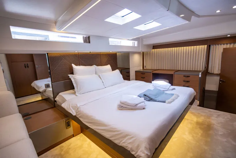  Yacht Photos Pics Luxurious bedroom interior of 2024 Prestige M48 yacht with modern design and elegant furnishings.