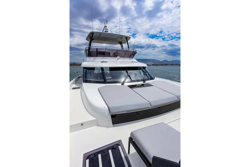  Yacht Photos Pics 2024 Prestige M48 yacht with sleek design, spacious deck, and modern features under a cloudy sky.