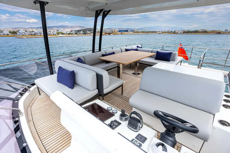  Yacht Photos Pics Luxurious 2024 Prestige M48 yacht deck with seating, table, and scenic ocean view.