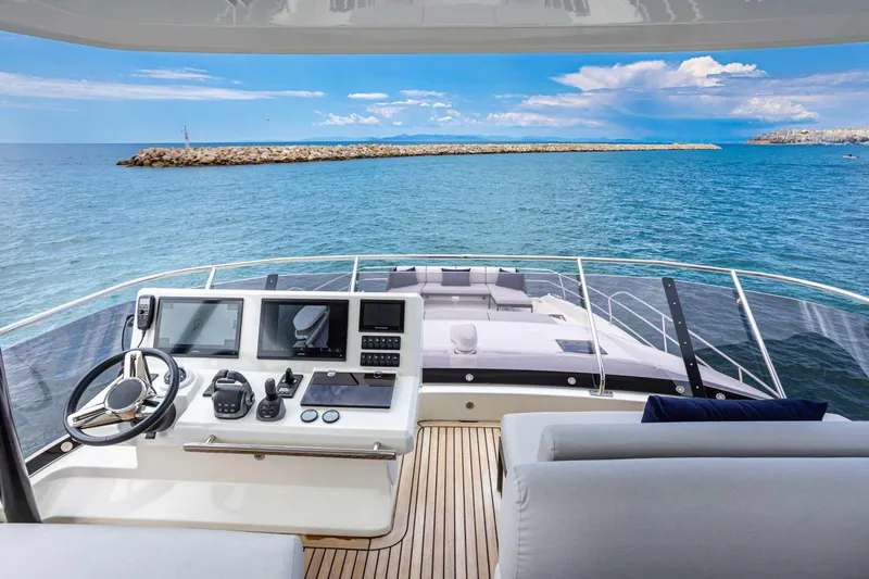  Yacht Photos Pics 2024 Prestige M48 yacht helm with ocean view, featuring modern navigation equipment.