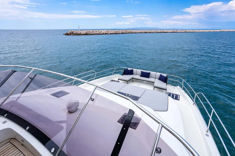  Yacht Photos Pics 2024 Prestige M48 yacht with luxurious deck seating, cruising on open sea.
