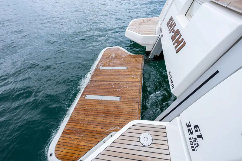  Yacht Photos Pics 2024 Prestige M48 yacht with wooden swim platform on calm water.